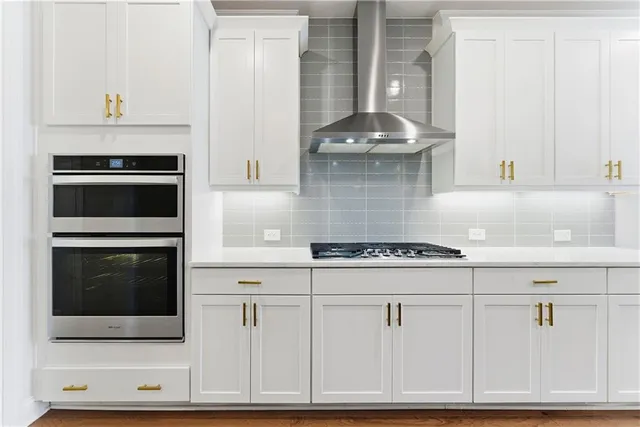 a kitchen with stainless steel appliances a refrigerator sink and cabinets