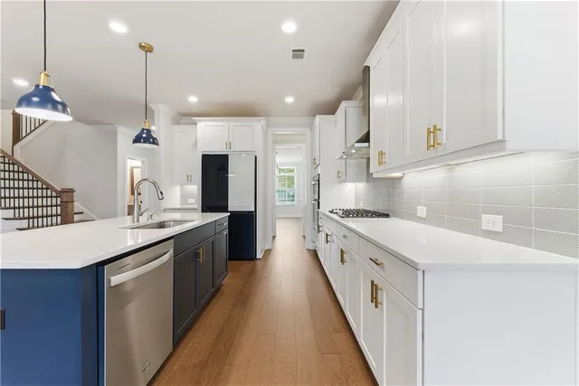 a kitchen with a stove and a wooden floor