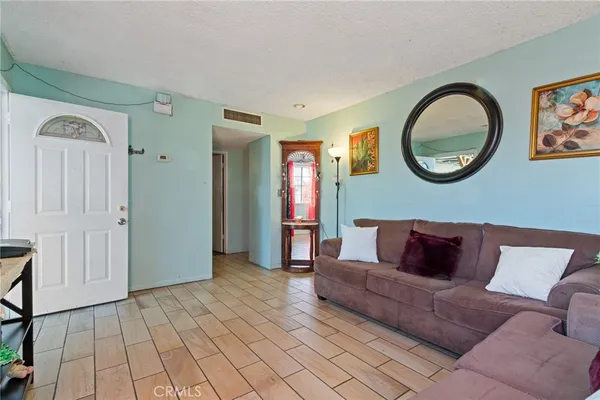 a living room with furniture and a mirror