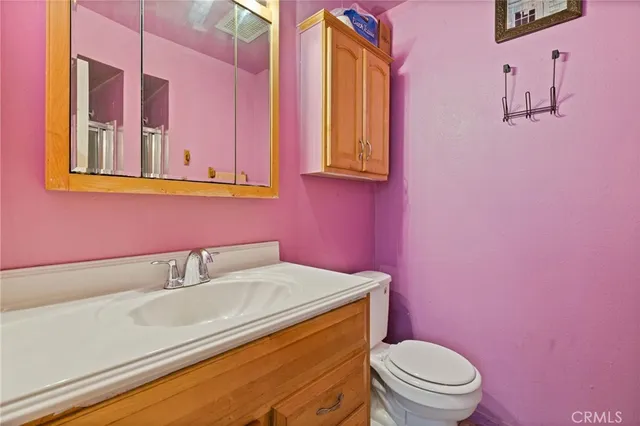 a bathroom with a sink a toilet and mirror