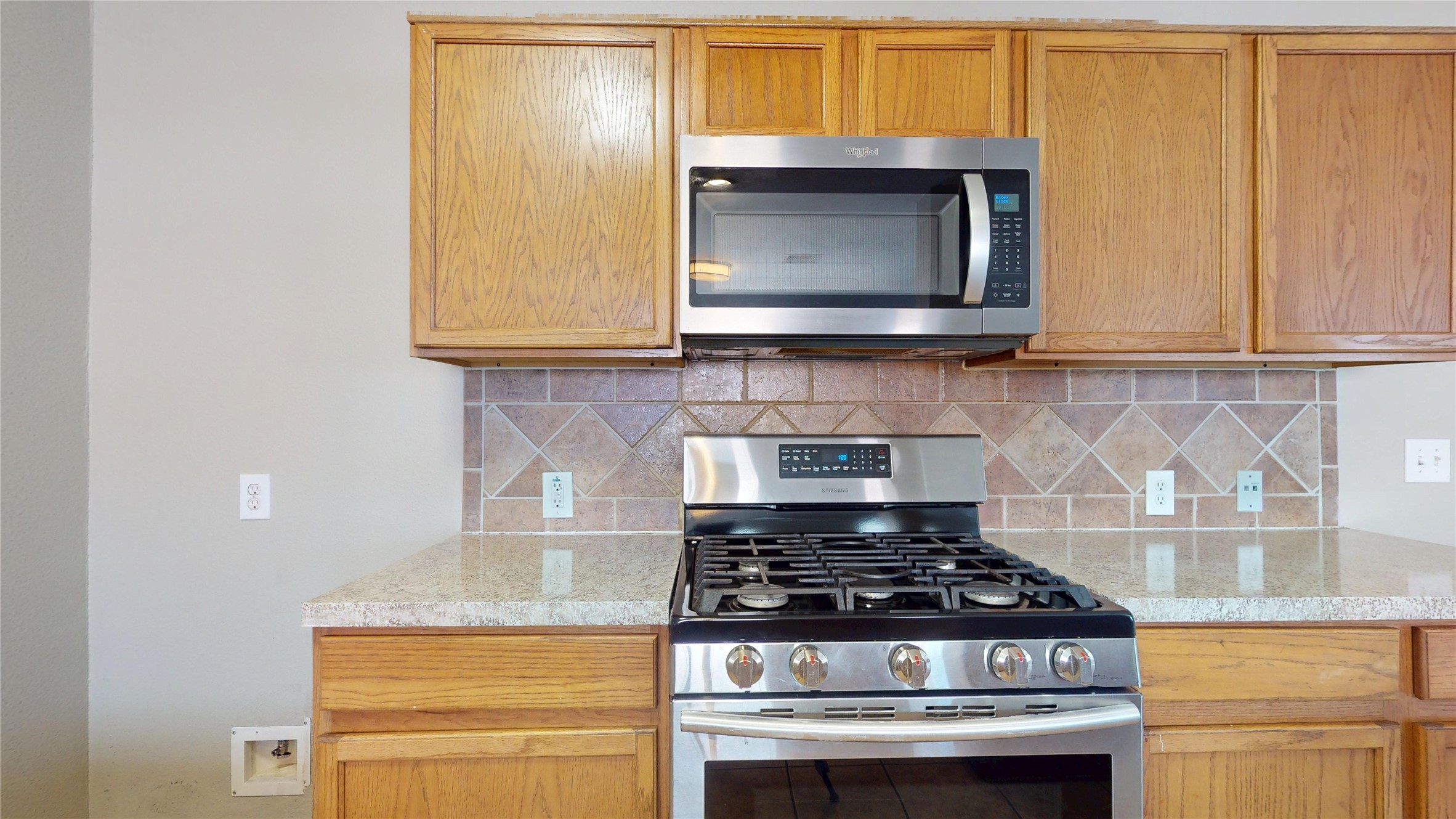 6007 Baldwin Elm Street Richmond, TX 77407 - Photo 14 of 45 a stove top oven sitting inside of a kitchen