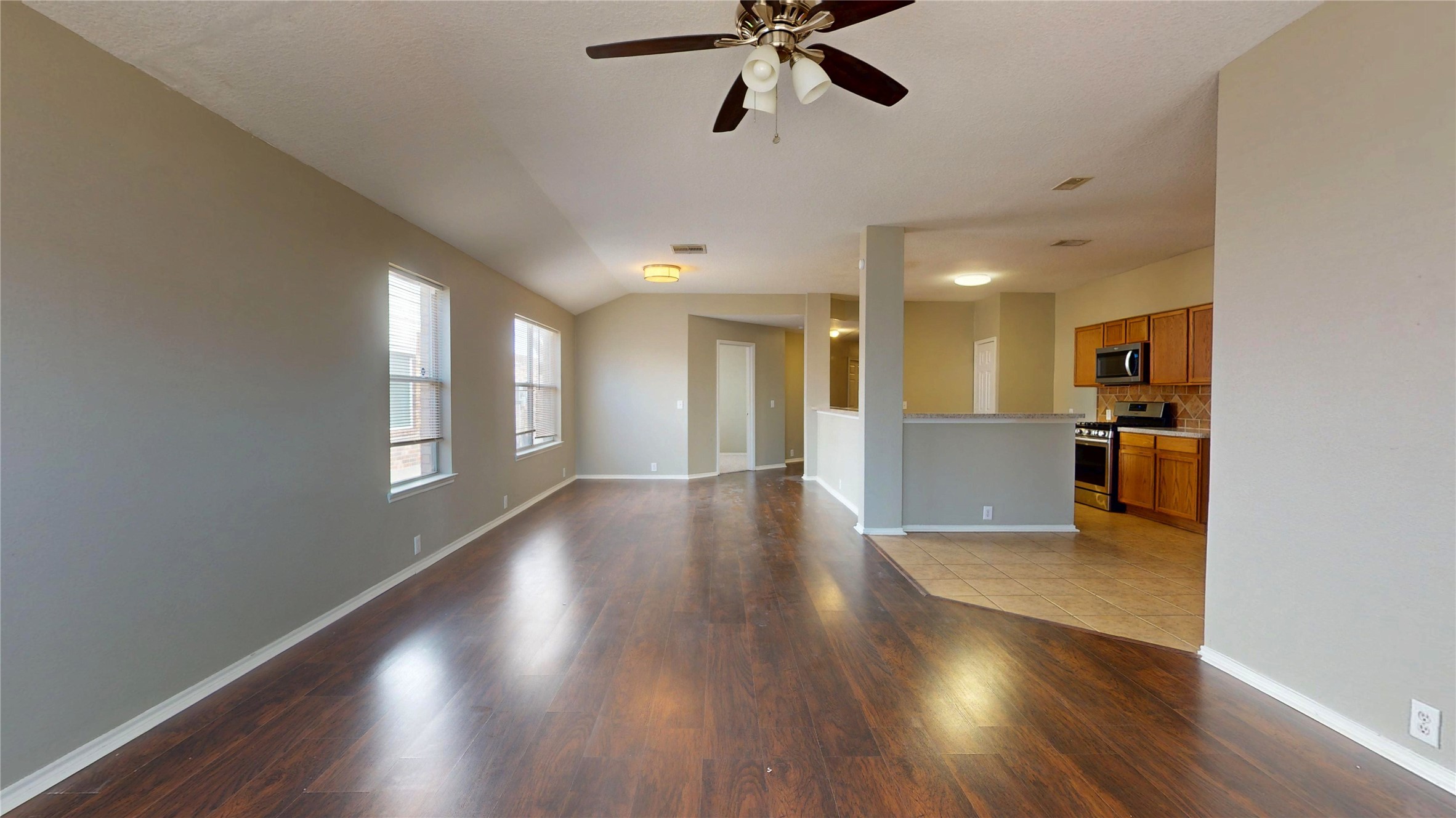 6007 Baldwin Elm Street Richmond, TX 77407 - Photo 18 of 45 a view of an empty room with wooden floor and a window