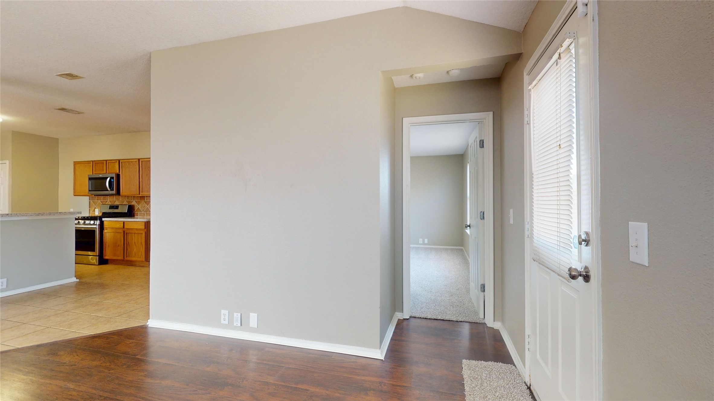 6007 Baldwin Elm Street Richmond, TX 77407 - Photo 19 of 45 a view of a hallway with wooden floor and a bathroom