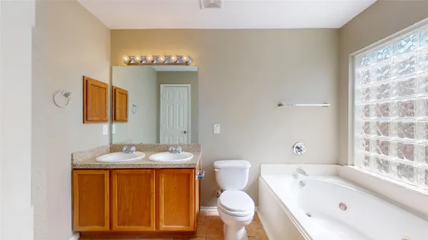 a white bath tub sitting next to a shower