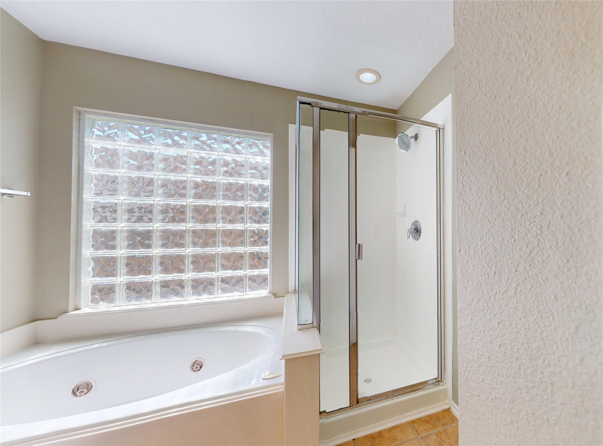 6007 Baldwin Elm Street Richmond, TX 77407 - Photo 26 of 45 a bathroom with a bathtub and a shower