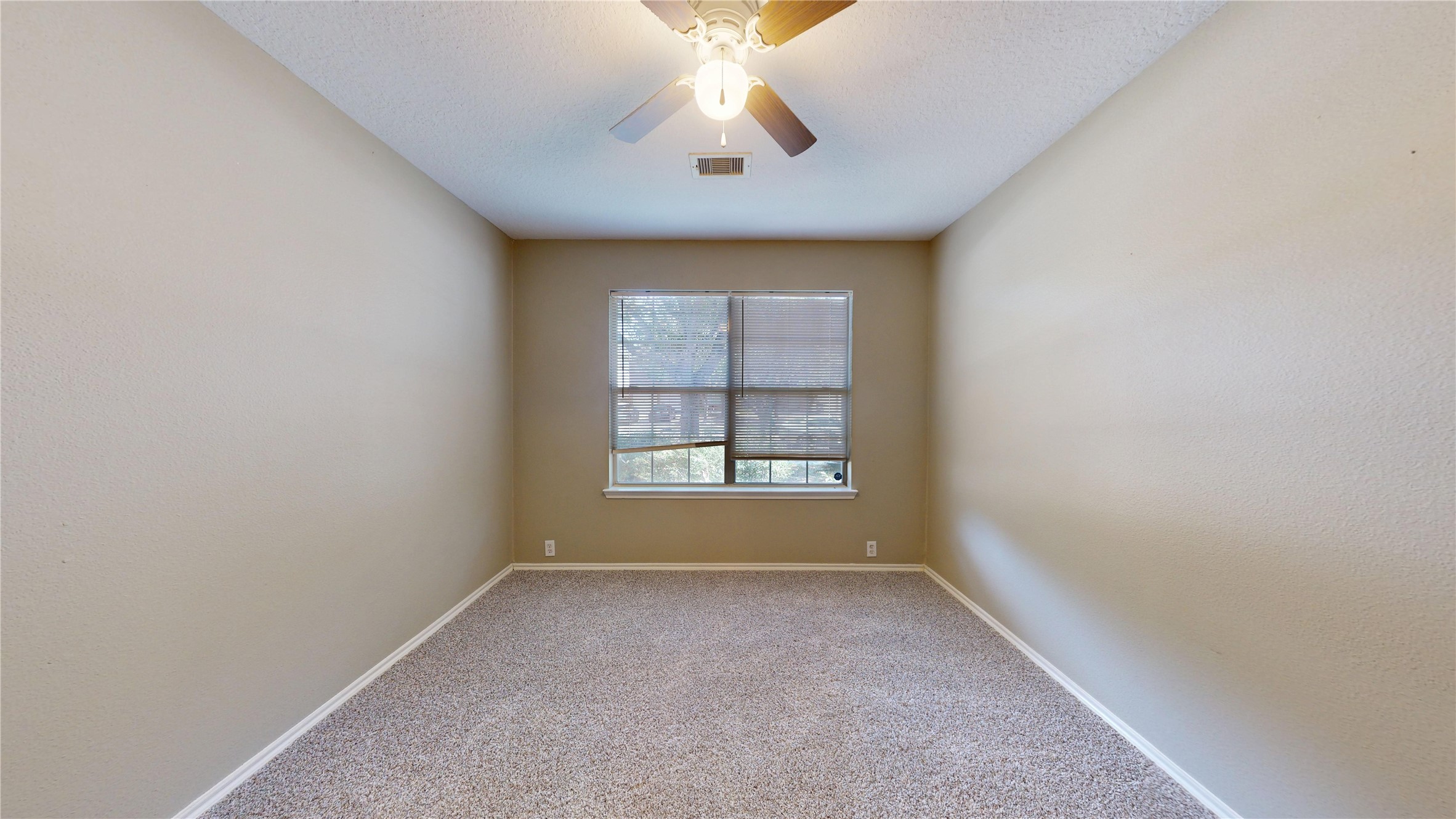 6007 Baldwin Elm Street Richmond, TX 77407 - Photo 31 of 45 an empty room with chandelier fan and windows