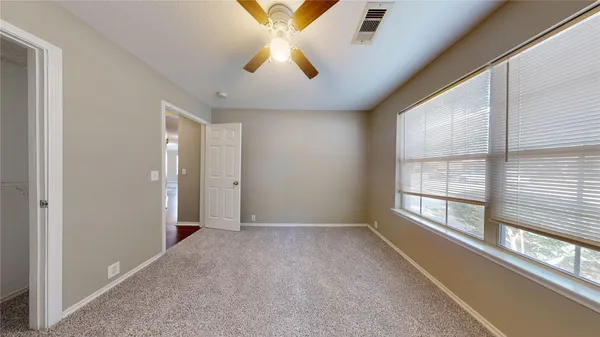 a view of a livingroom with a ceiling fan and window