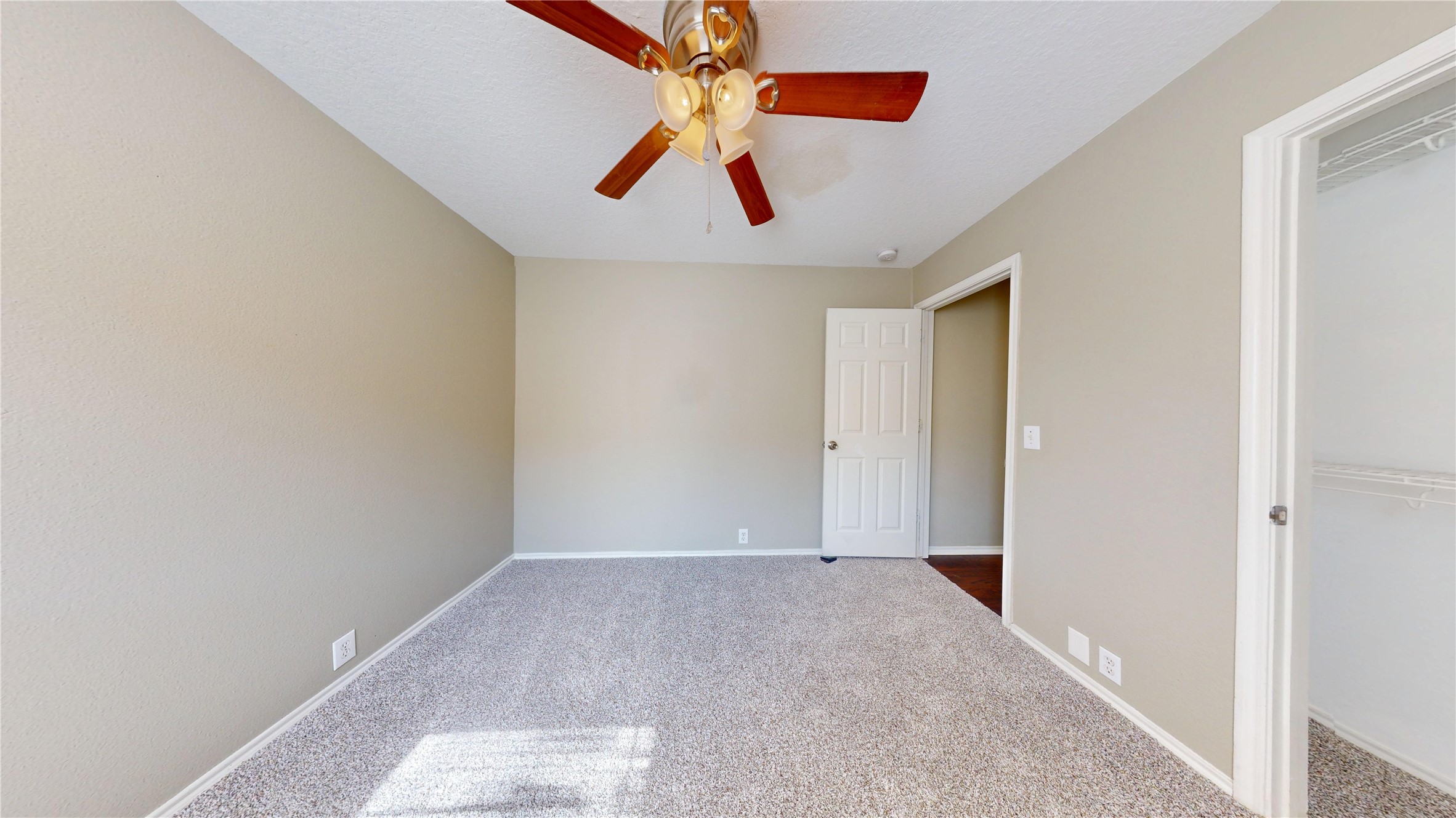 6007 Baldwin Elm Street Richmond, TX 77407 - Photo 34 of 45 an empty room with chandelier fan
