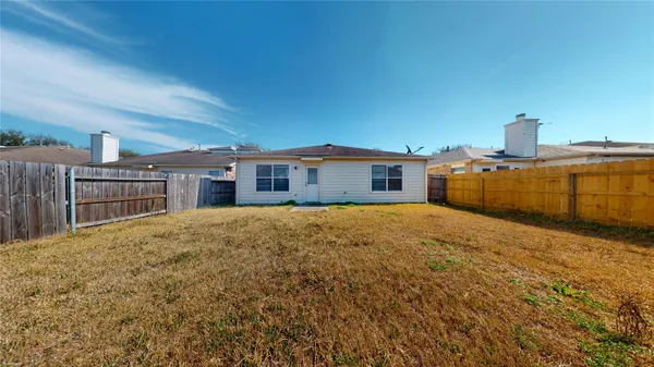 a view of multiple houses with yard