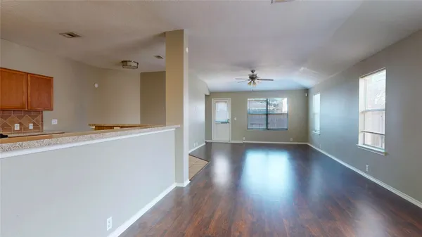 a view of kitchen with microwave and wooden floor