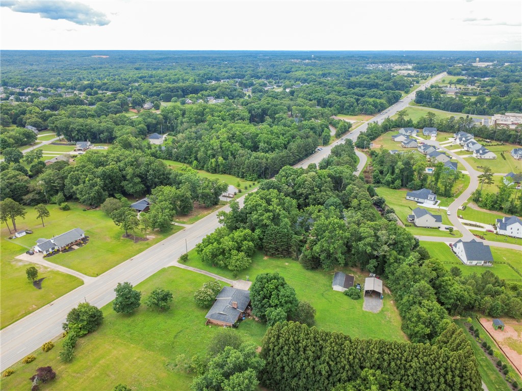 3080 McGee Road Iva, SC 29655 - Photo 45 of 49 An aerial perspective reveals a vast, verdant landscape with homes nestled amongst dense trees and winding roads.