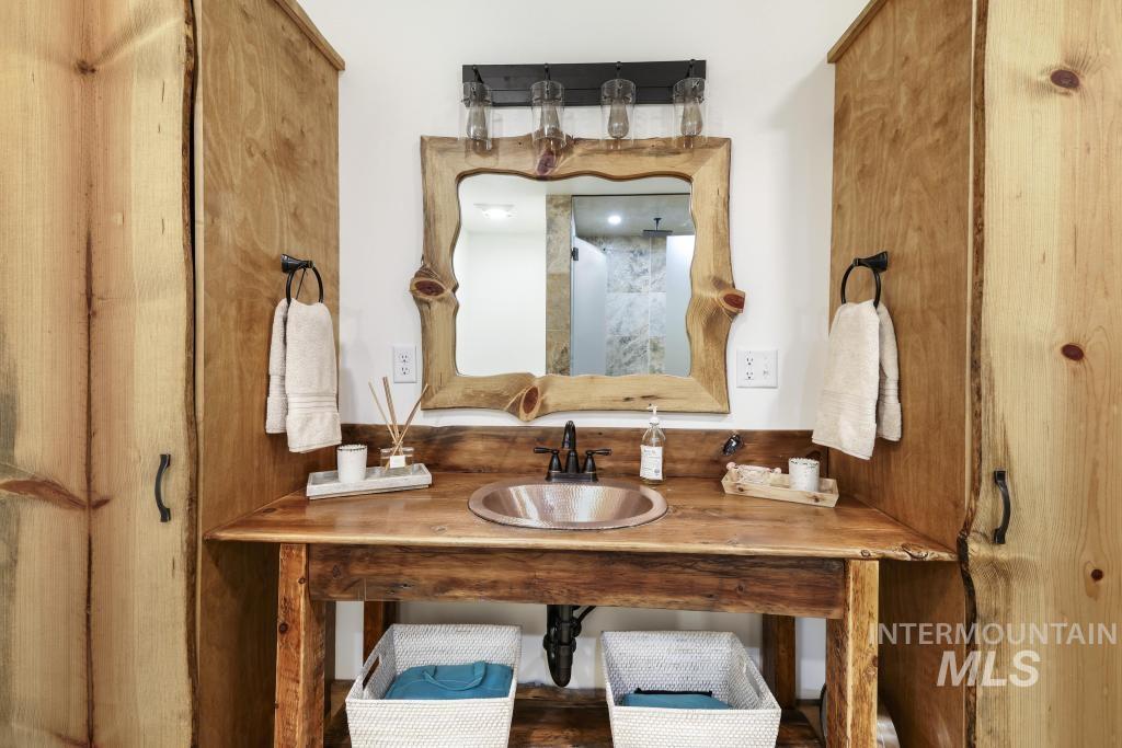 65 Goat Creek Way Stanley, ID 83278 - Photo 22 of 32 Custom wood vanity with integrated copper sink