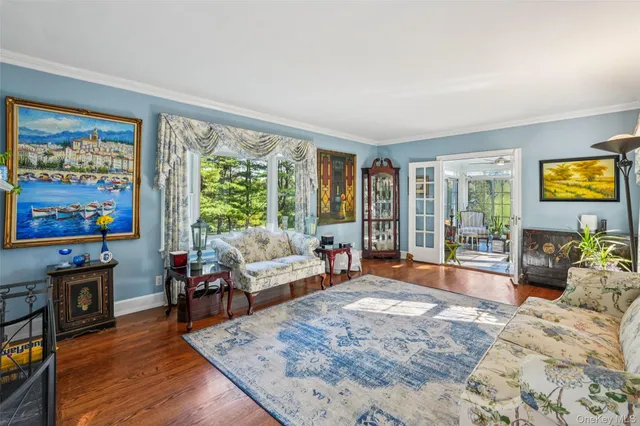 a bedroom with furniture and a flat screen tv