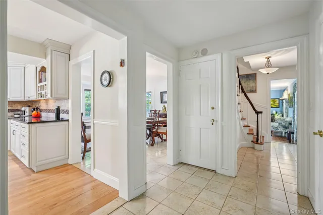 a view of a hallway view with wooden floor and dining room