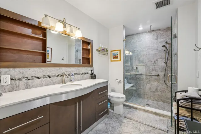 a bathroom with a bathtub shower sink mirror and toilet