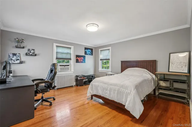 a bedroom with a bed a desk and chair