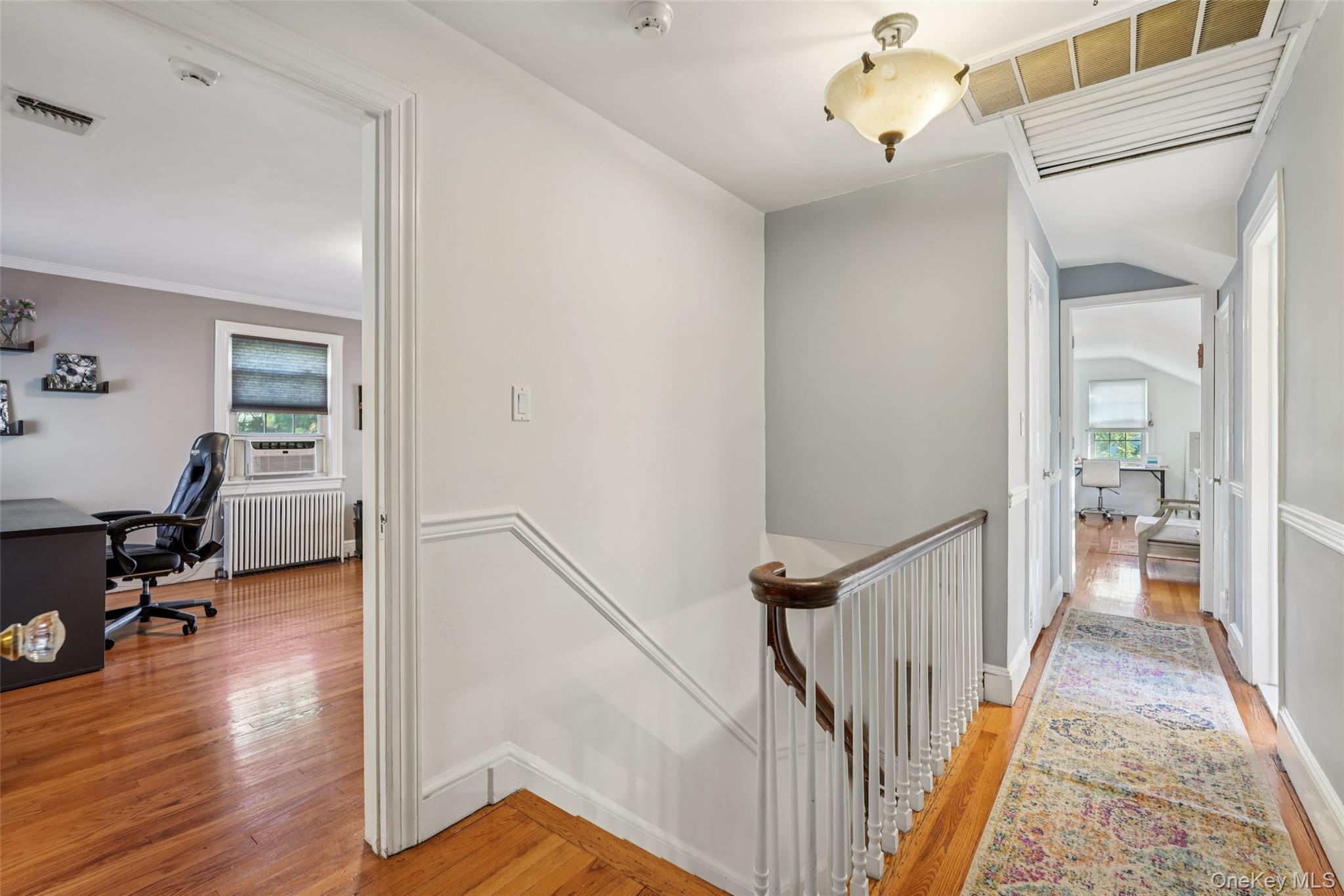 8 Abbey Road West Nyack, NY 10994 - Photo 22 of 38 a view of a hallway to a livingroom with wooden floor and furniture