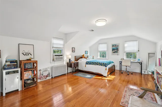 a bedroom with furniture and a wooden floor