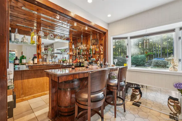 a dining room with furniture and large windows