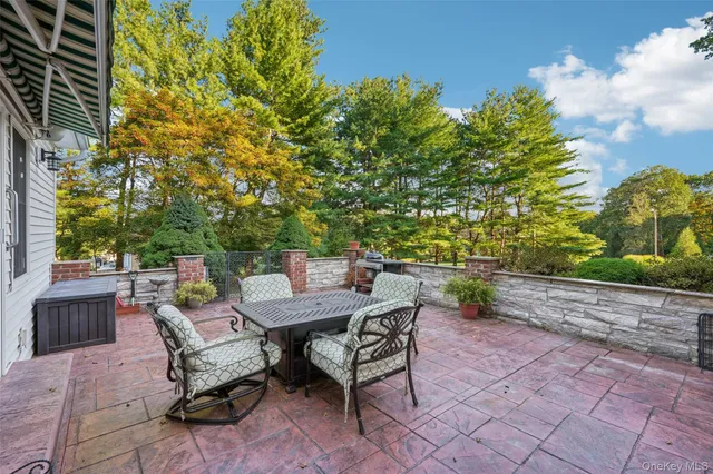 a backyard of a house with table and chairs