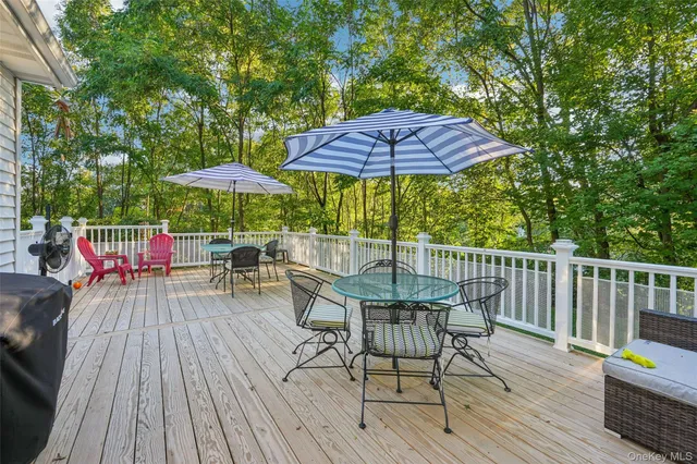 a view of deck with furniture and barbeque oven with wooden floor