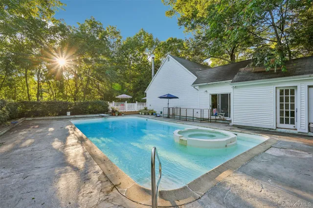 a view of a house with swimming pool and sitting area