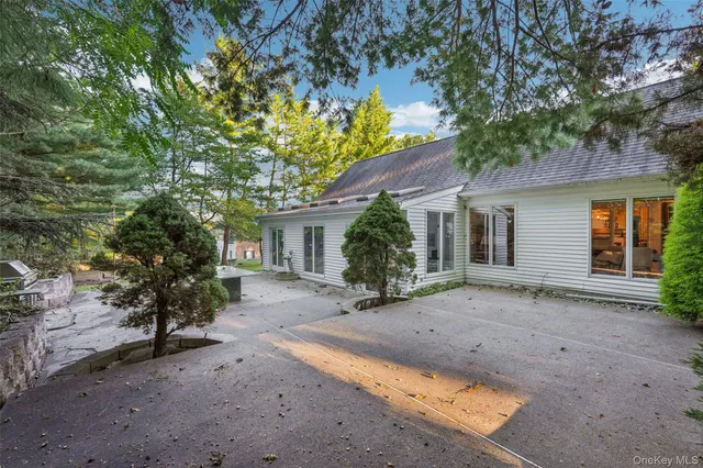 a view of a house with a tree in front of it
