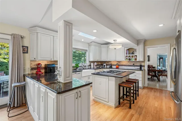 a kitchen with stainless steel appliances granite countertop a stove and cabinets