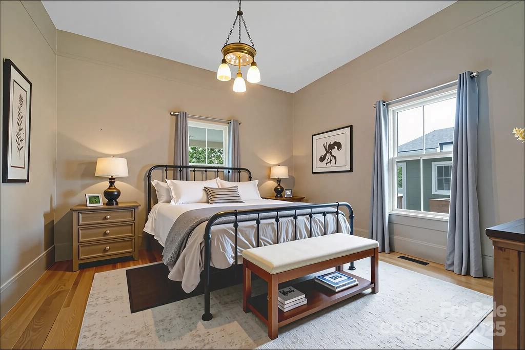 363 North Country Club Road Brevard, NC 28712 - Photo 21 of 42 a bedroom with a bed and a chandelier