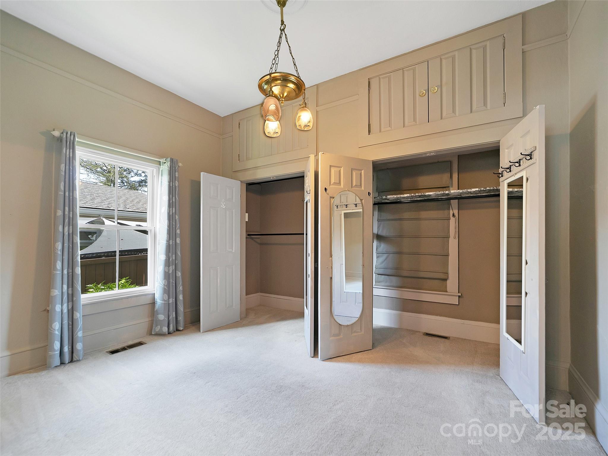 363 North Country Club Road Brevard, NC 28712 - Photo 24 of 42 a view of an empty room with a fireplace and a window