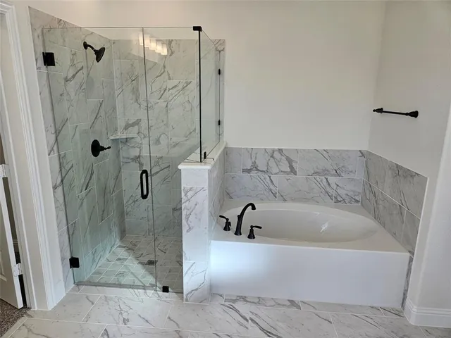 a bathroom with a bathtub and shower