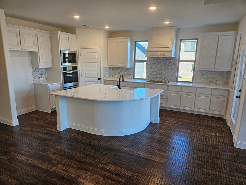 1529 Enloe Road Howe, TX 75459 - Photo 2 of 30 a large kitchen with stainless steel appliances granite countertop a sink a stove a refrigerator and white cabinets