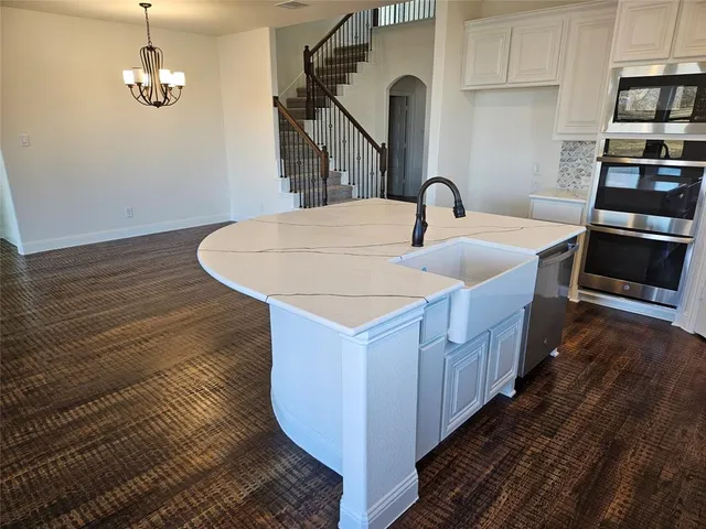 a kitchen with sink and kitchen island