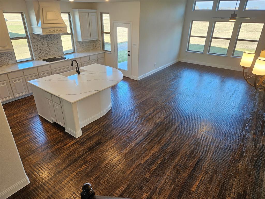 1529 Enloe Road Howe, TX 75459 - Photo 6 of 30 a view of an empty room with wooden floor and a window