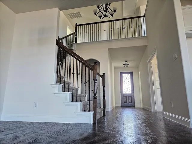 a view of entryway with wooden floor and stairs