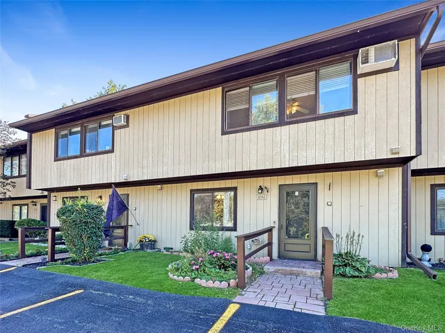 a front view of house with a garden