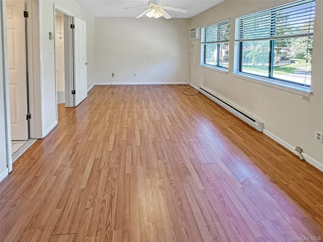 wooden floor in an empty room with a window