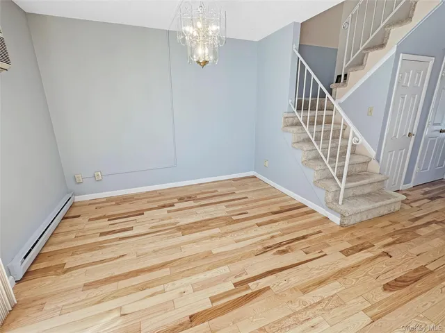 a view of a room with wooden floor and staircase