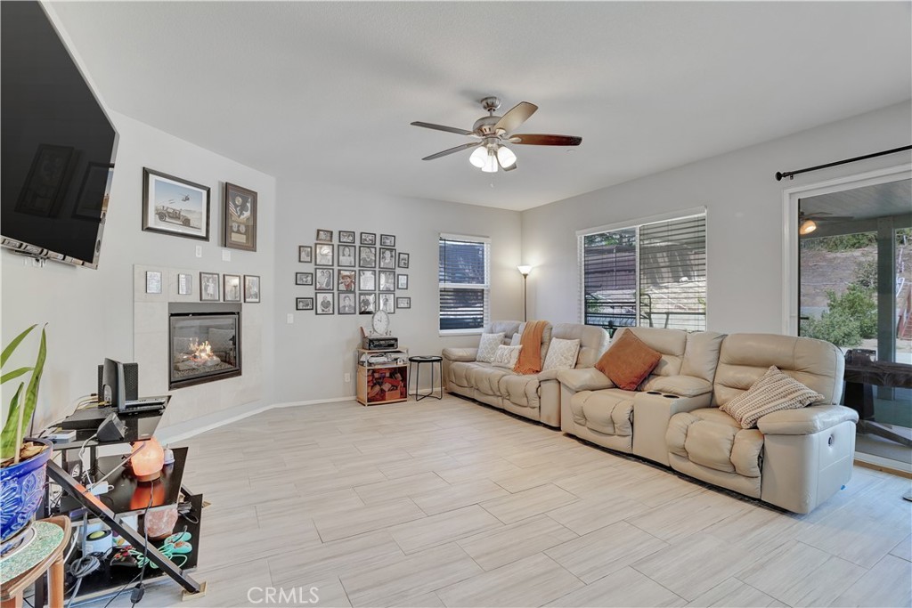 12179 Dewar Drive Riverside, CA 92505 - Photo 12 of 53 a living room with furniture a fireplace and a flat screen tv