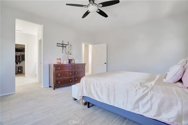 a bedroom with a bed and ceiling fan