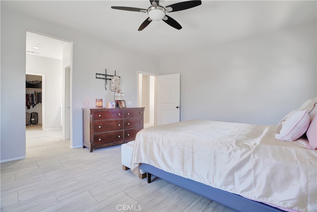 12179 Dewar Drive Riverside, CA 92505 - Photo 17 of 53 a bedroom with a bed and ceiling fan