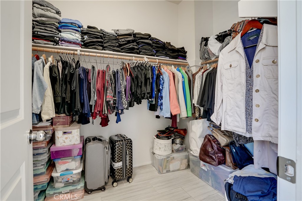 12179 Dewar Drive Riverside, CA 92505 - Photo 20 of 53 a view of walk in closet with clothes and shoes
