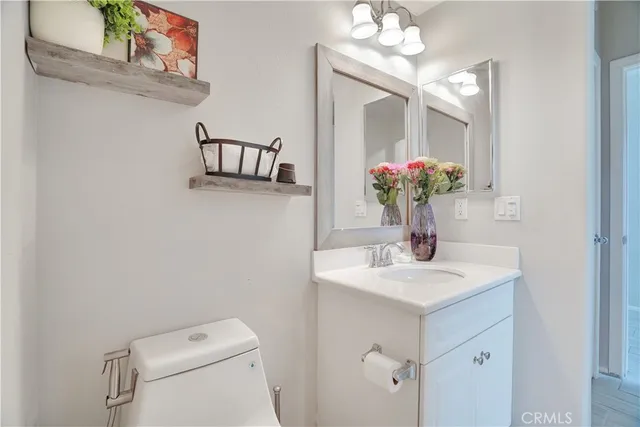 a bathroom with a sink vanity and a mirror