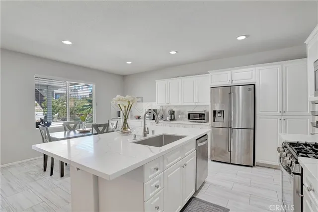 a kitchen with a center island appliances and cabinets