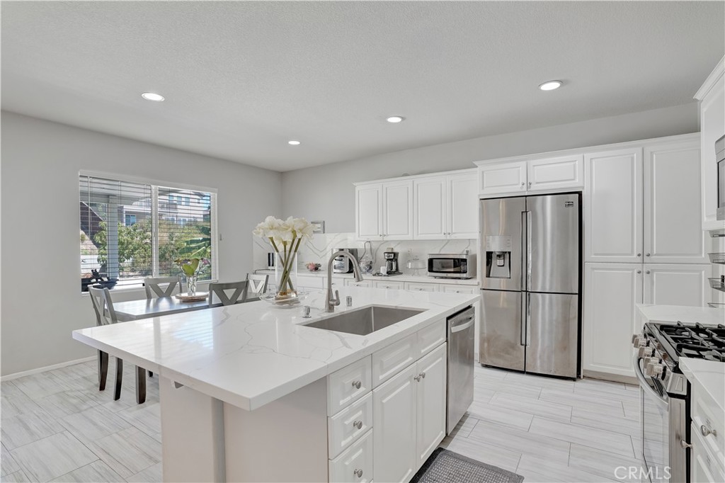 12179 Dewar Drive Riverside, CA 92505 - Photo 4 of 53 a kitchen with a center island appliances and cabinets