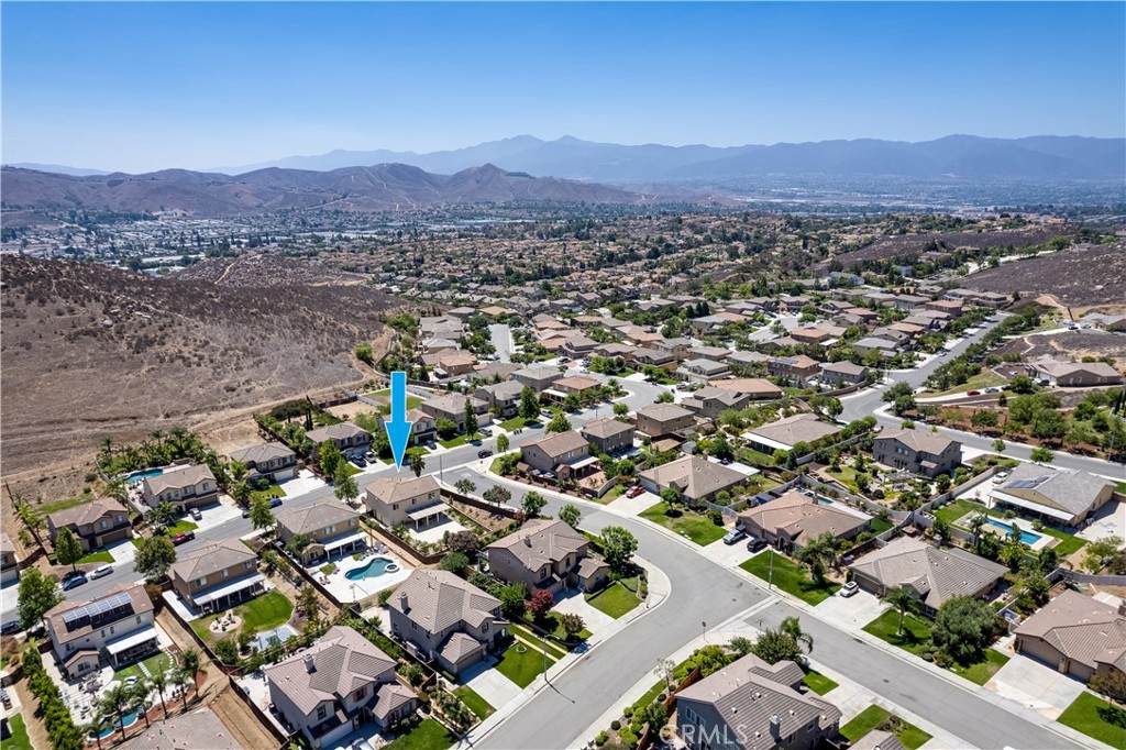 12179 Dewar Drive Riverside, CA 92505 - Photo 46 of 53 an aerial view of a city with lots of residential buildings and mountain view in back