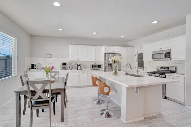 a view of kitchen with cabinets table and chairs