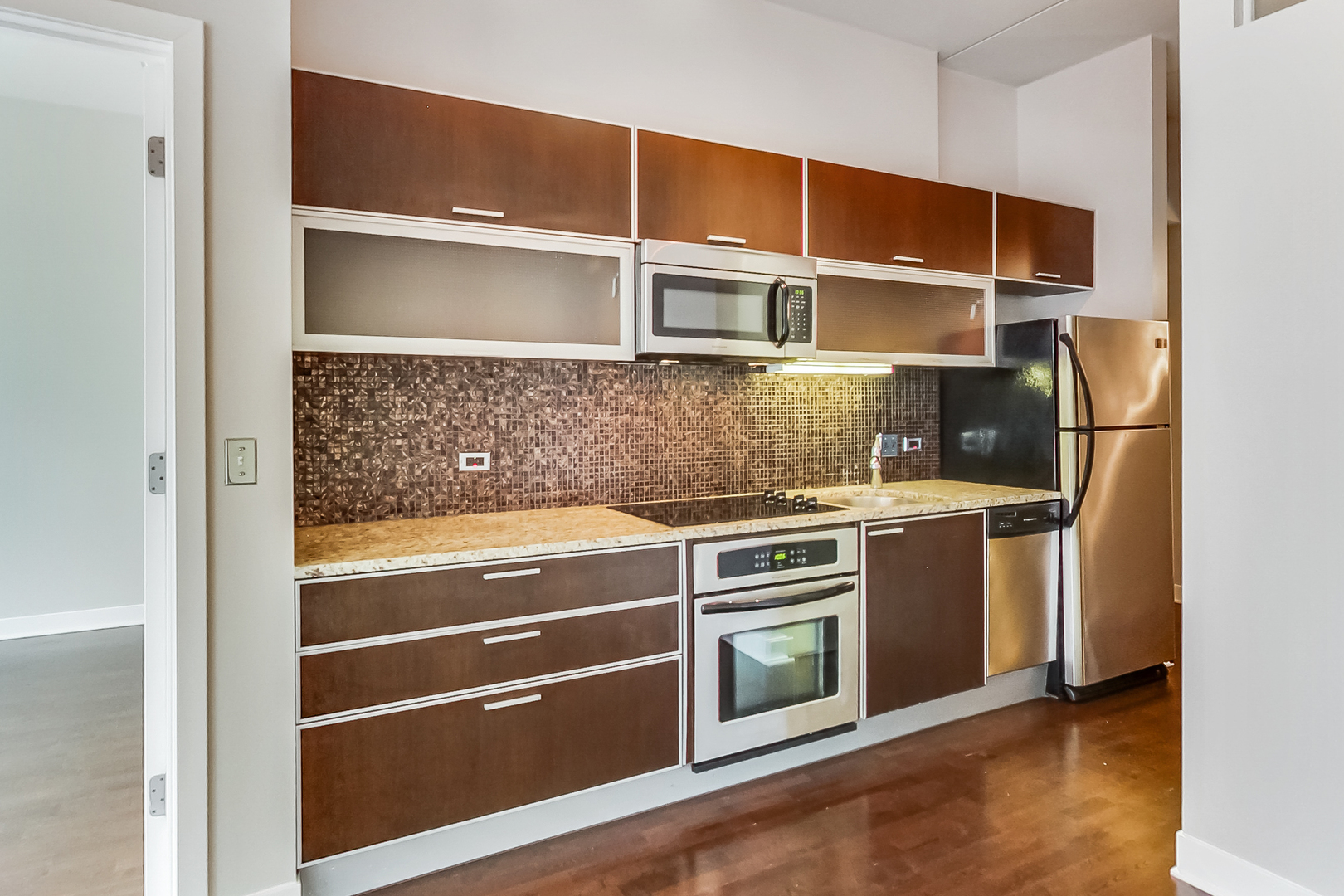650 West Wayman Street, Unit 503C Chicago, IL 60661 - Photo 6 of 23 a view of an empty room with wooden floor and cabinets