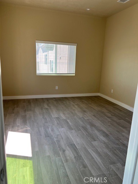 4855 Grace Avenue Cypress, CA 90630 - Photo 7 of 15 an empty room with wooden floor and a window
