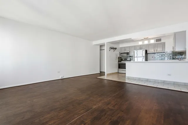 a view of a kitchen with wooden floor